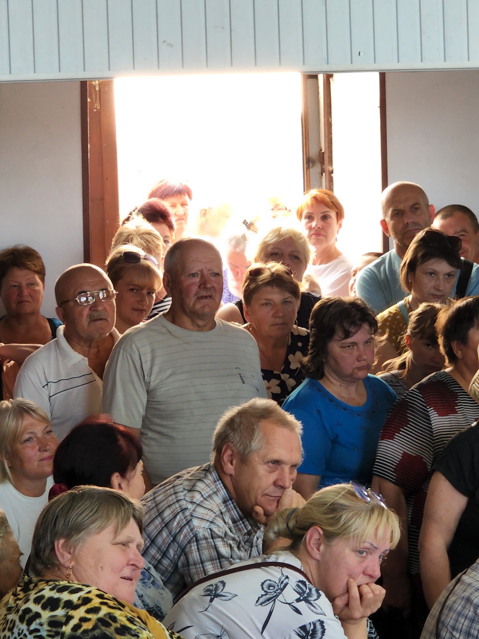 People gathered at an aid distribution in Ukraine