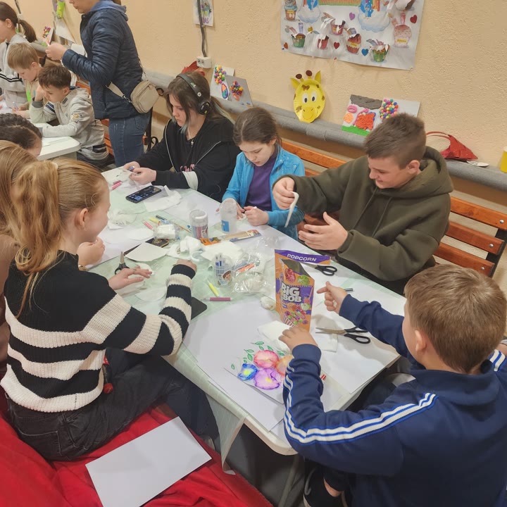 Young people studying together around a table at the youth center